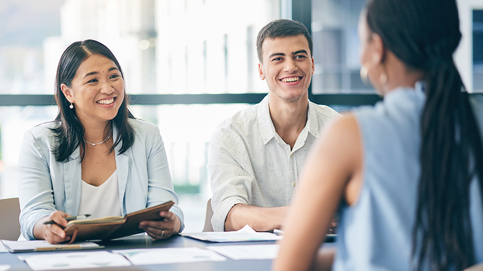 Image of a man and a woman interviewing someone for a job
