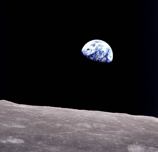 Earth peeking out from beyond the lunar surface.