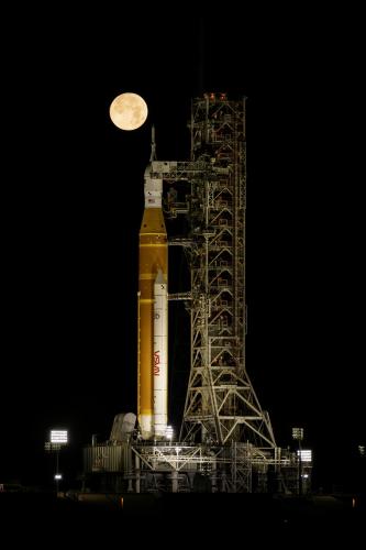 rocket on the launch pad with full moon in background 