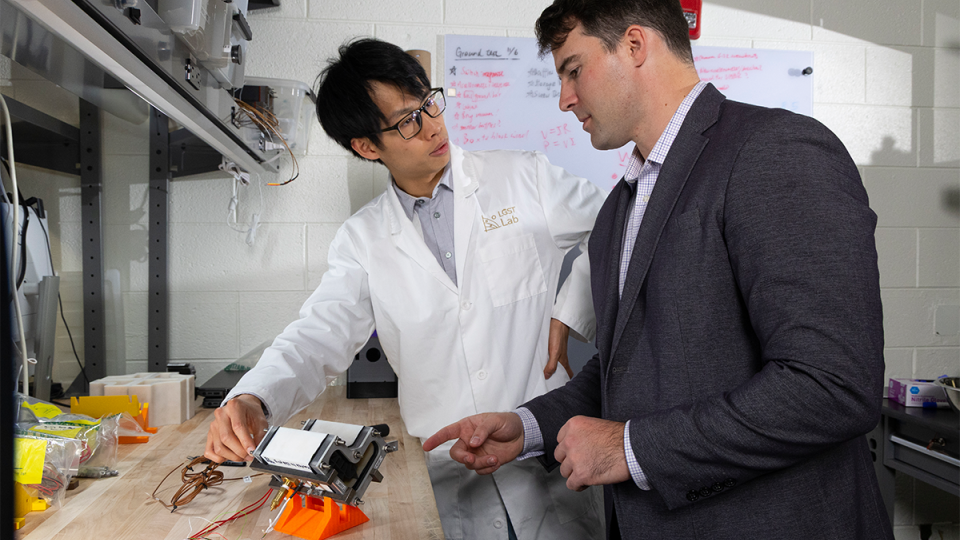 Trenton Gantt and Hugh (Ka Yui) Chen work together in the lab